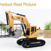 A yellow 1:24 scale remote control excavator with a bucket and tracks is shown on a white background.