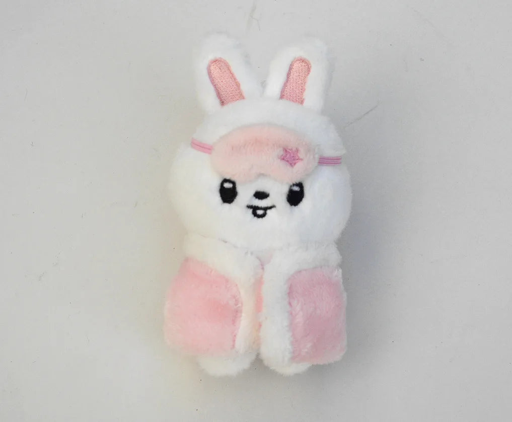 A white and pink cartoon rabbit plush keychain with long ears and a small pink flower detail.