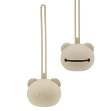 A light beige silicone panda-themed pacifier storage bag with a long loop for hanging.