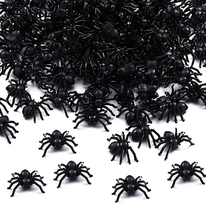 A pile of realistic fake black spiders for Halloween decor and pranks.