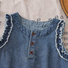 A denim sleeveless dress for a toddler girl featuring lace trim on the neckline and armholes.
