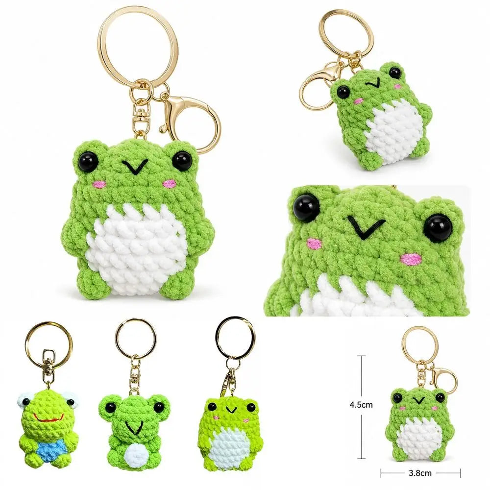 A set of crochet frog keychains featuring soft green and white yarn, including a bag charm and key ring.