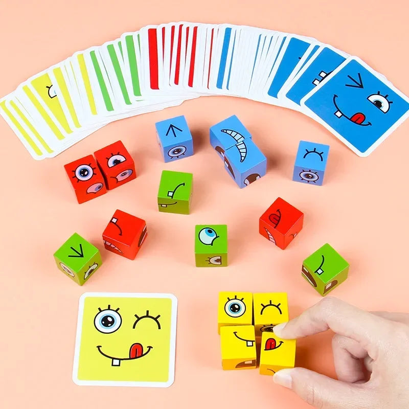 A hand holds a yellow face-changing cube puzzle game with smiling eyes and a mouth, surrounded by various colored wooden cube