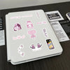 A white notebook features various pink and purple aesthetic stickers, including illustrations of a cat, heart, and phone.