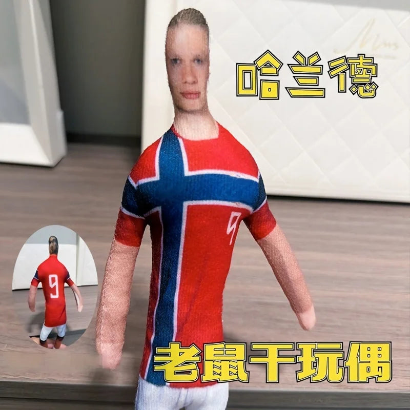 A realistic stuffed doll of Erling Haaland with flexible joints, shown in a full-body pose.