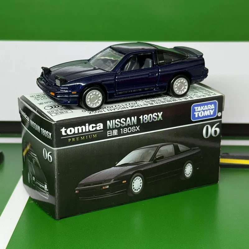 A dark blue Tomica Nissan 180SX die-cast sports car model displayed on its packaging.