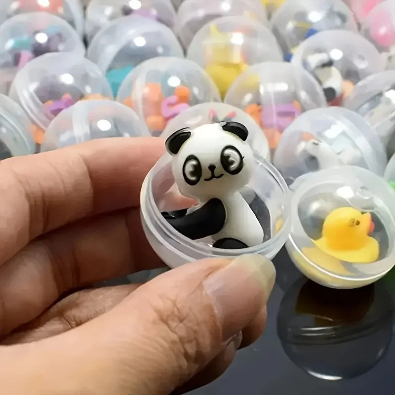 A hand holds a white and black panda mini capsule figure among many colorful collectible figures.