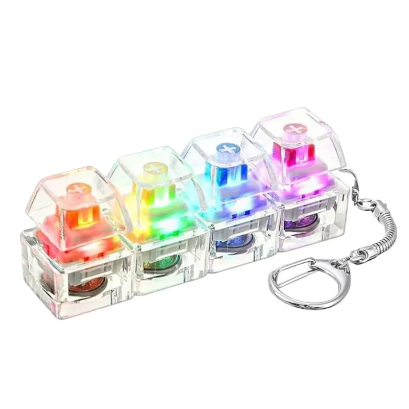 A clear plastic keychain toy featuring multiple illuminated buttons in various colors like red, green, blue, and purple.