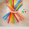 A collection of colorful wooden pumping sticks arranged in a starburst pattern on a light wooden floor.