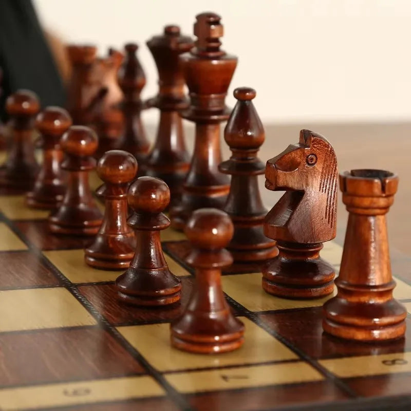 A wooden magnetic 3-in-1 chess, checkers, and backgammon set with dark wood pieces on a board.