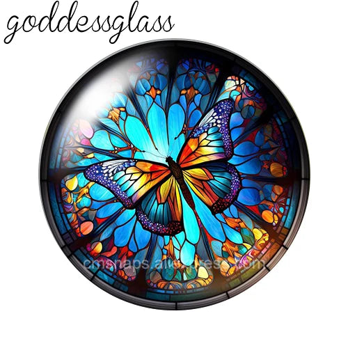 A round glass cabochon featuring a vibrant blue and orange butterfly design.