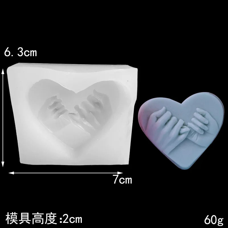 White silicone mold shaped like a heart, used for making candles, soaps, or desserts.