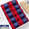 A box of ten skeins of red YEDAN MERIN worsted wool thread yarn for knitting projects.