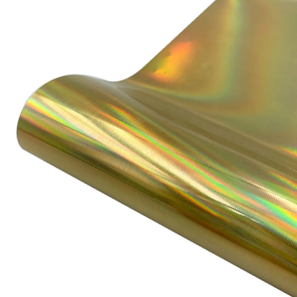 A close-up of a roll of holographic glitter heat transfer vinyl showing iridescent colors and a smooth texture.