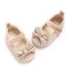 Pair of light pink soft cotton baby walking shoes with gold glitter bow details