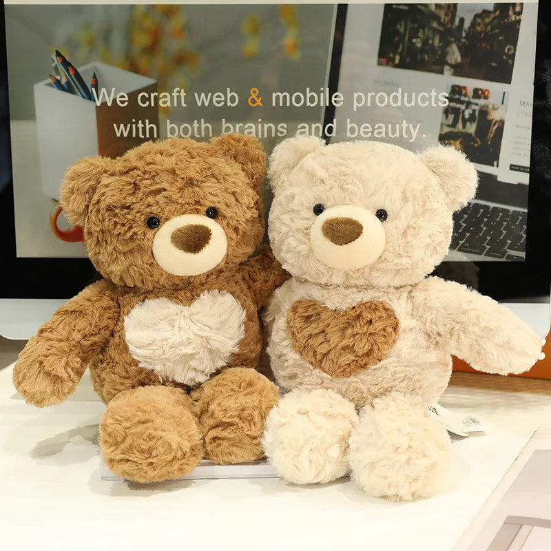 A pair of fluffy brown and cream teddy bears sitting side by side on a white surface.