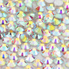 A close-up view of iridescent glass crystal flatback rhinestones in various colors and shapes.