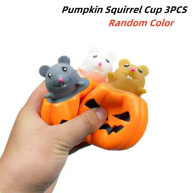 Three pumpkin and squirrel themed squeeze stress balls in random colors being held in a hand.