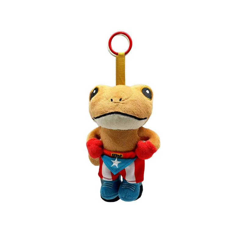 A cute plush frog doll with a yellow body and orange feet, wearing a patriotic star design, hanging from a red loop.