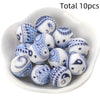 A collection of ten small, white and blue patterned silicone beads for DIY jewelry making.