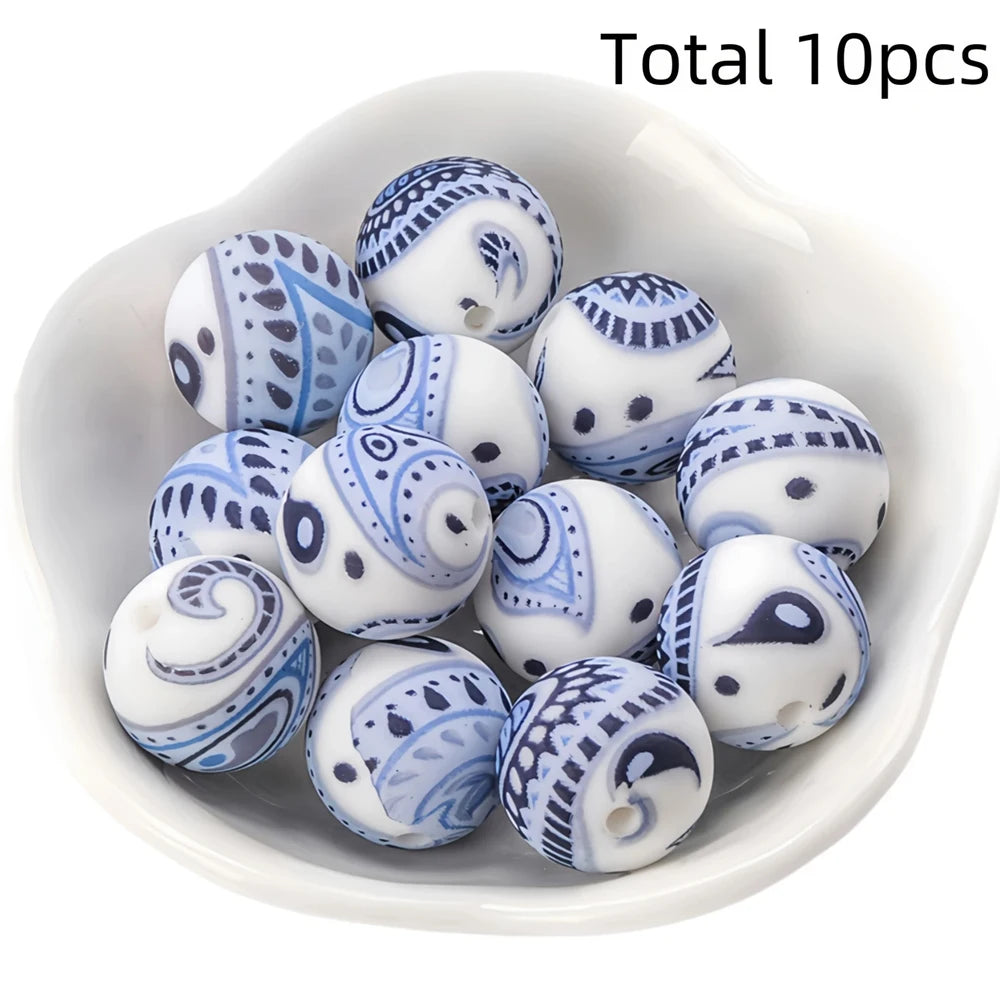 A collection of ten small, white and blue patterned silicone beads for DIY jewelry making.