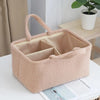 Sac organisateur multifonction beige pour bébé avec doublure rembourrée et tissu rayé, sur une table blanche.