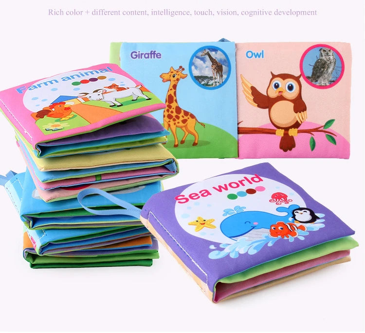 A collection of soft cloth books featuring different animals like giraffe, owl, and sea creatures for baby learning.