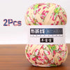 A ball of pink and green patterned soft chunky t-shirt yarn for crochet and knitting, packaged as a 2-pack.