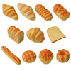 A collection of various baked bread shapes and textures, including croissants, rolls, and slices.