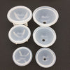 Four clear silicone molds shaped like spheres or cups for resin crafting