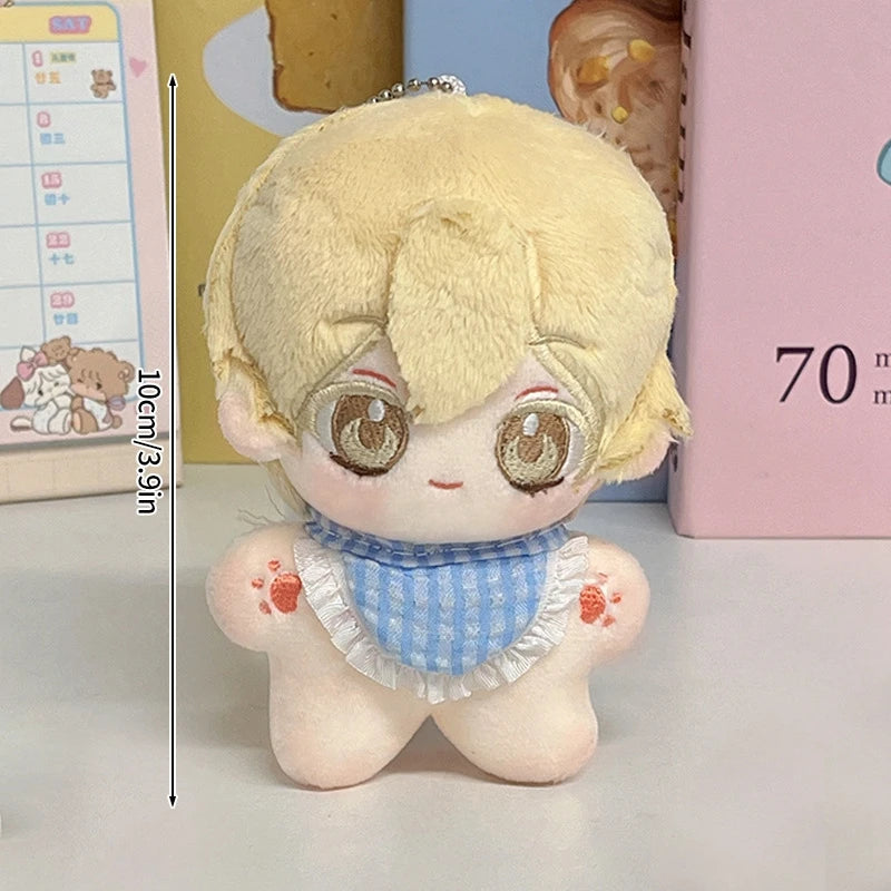 A light blonde plush keychain featuring an adorable face with large eyes and a blue patterned collar.