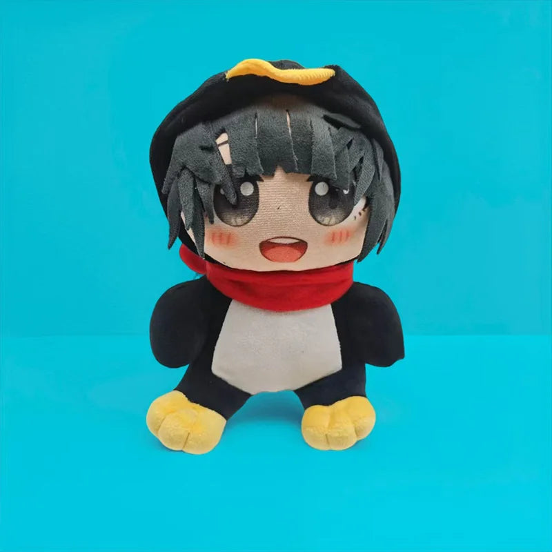 A cute plush toy of a penguin with black hair, a red scarf, and yellow feet against a blue background.