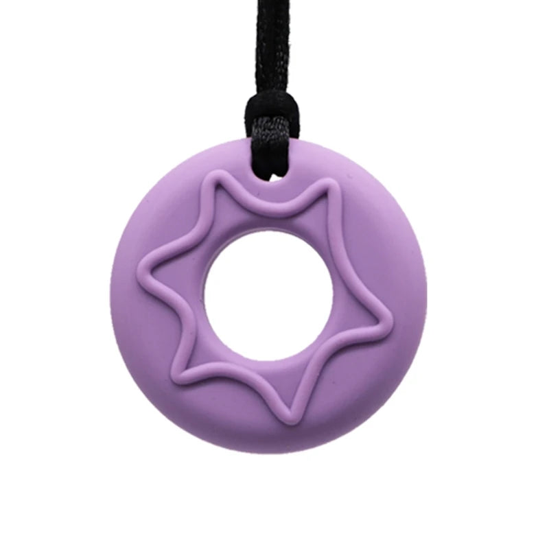 A purple silicone chew necklace with a star-shaped design and a black cord.