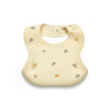 A beige soft silicone waterproof baby bib with an adjustable neck and rainbow accents.