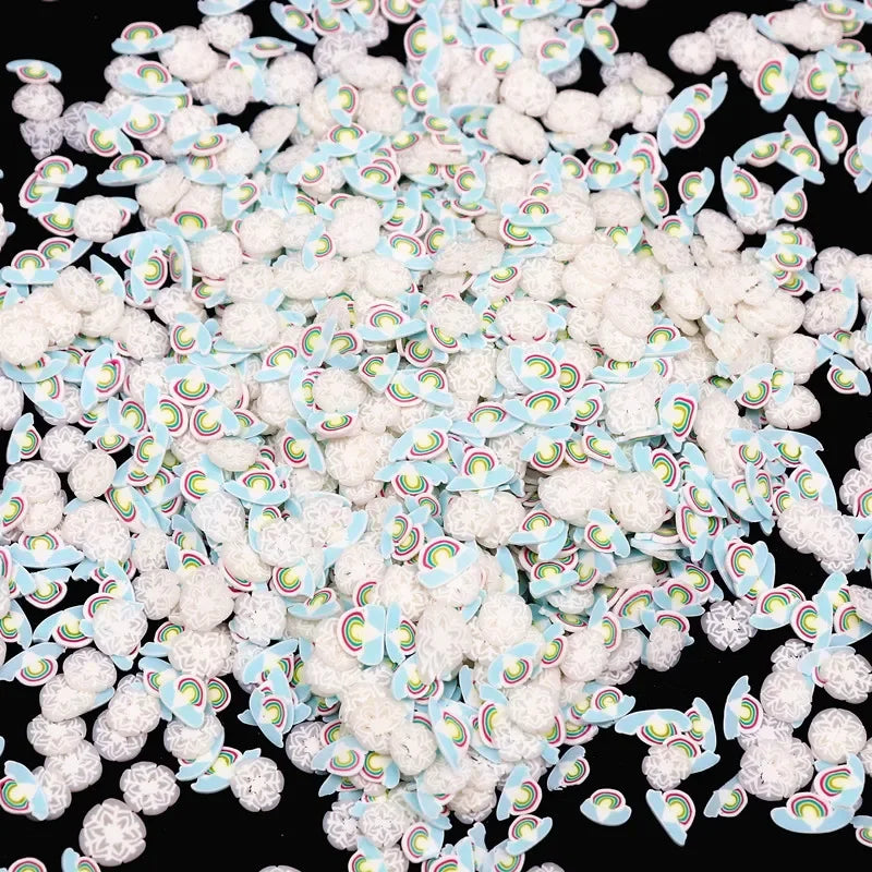 A pile of small polymer clay flower charms in various pastel colors and shapes.
