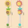 A yellow sunflower bath shower sprinkler toy with a green handle and a pink flower head.