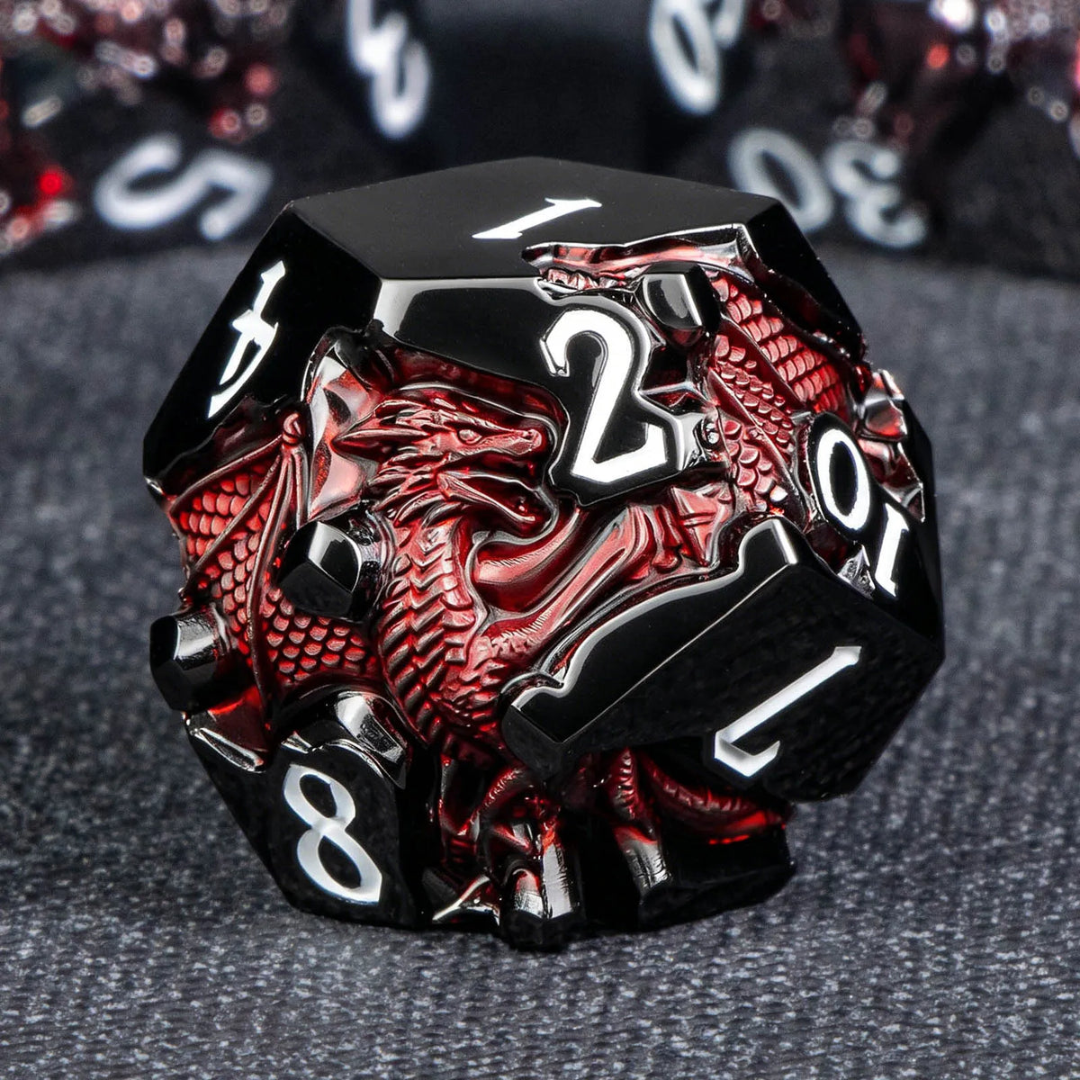 A black and red dragon-themed metal die showing the number 1.