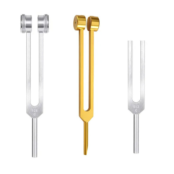 A set of tuning forks, including silver and gold, used for chakra healing.
