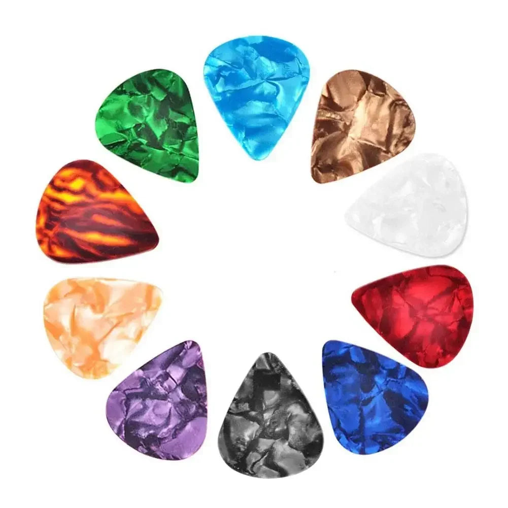A collection of ten guitar picks in assorted colors and thicknesses arranged in a circle.