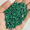 A handful of bright green natural tumbled stone chips for jewelry making and home decor
