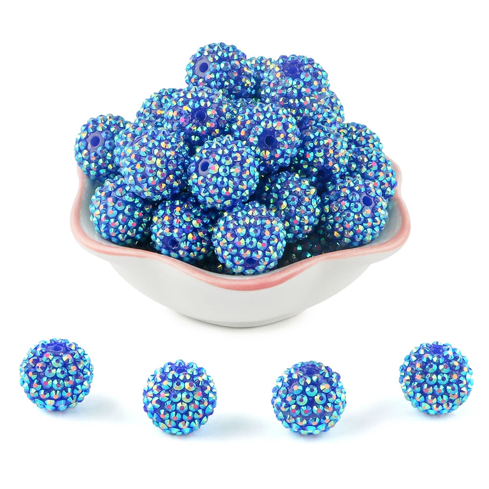 A pile of blue and purple rhinestone resin bayberry beads for jewelry making.