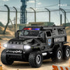 A black SWAT City Police truck diecast toy with lights and sounds parked outdoors.