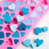 A pink silicone mold set featuring various heart shapes in blue and light blue colors.