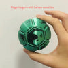 A hand holds a green fidget toy with a barren wood line design.