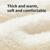 Close-up of a thick, soft, cream-colored blanket with a fluffy texture.
