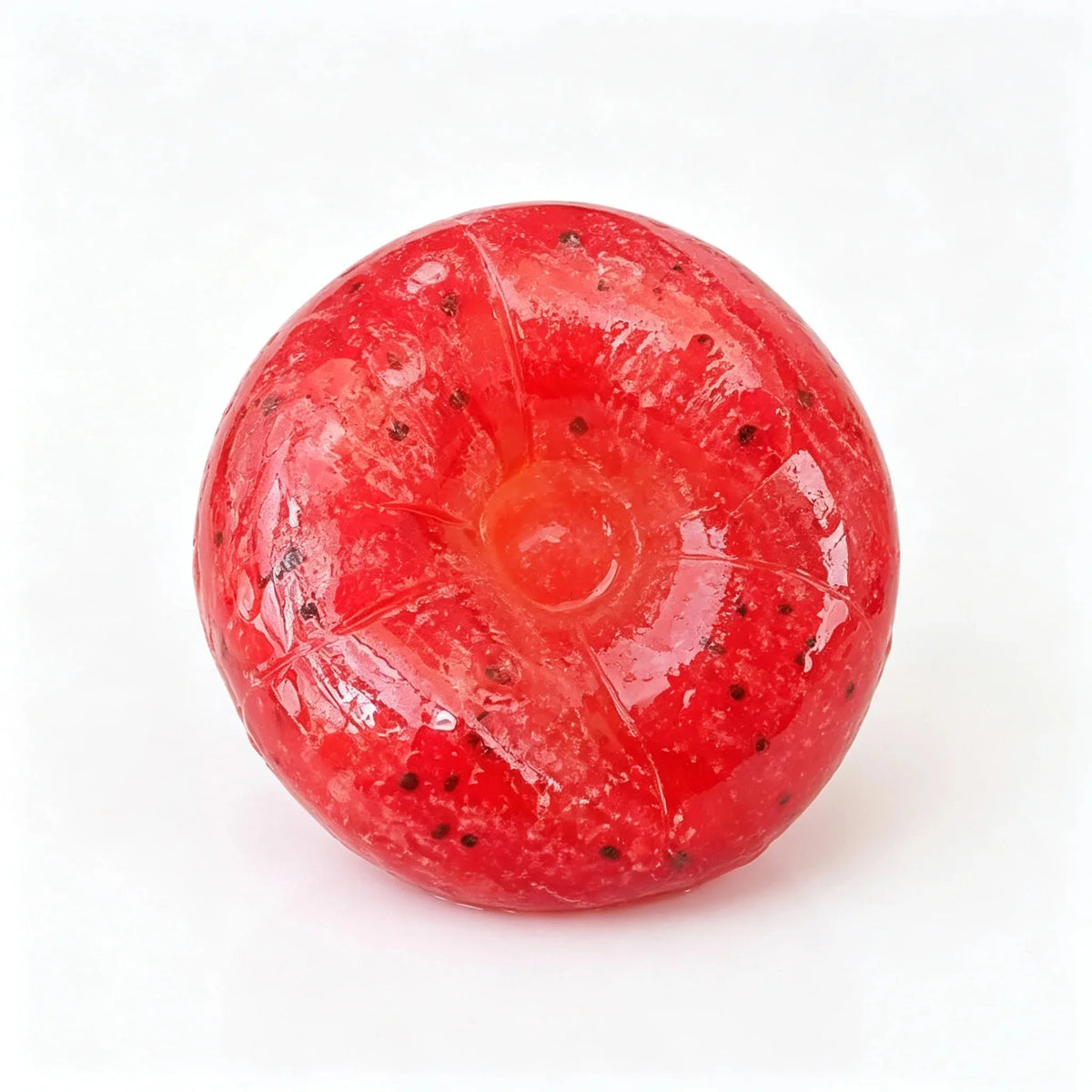 A bright red, spherical slime squishy toy shaped like a kiwi fruit with visible seeds.