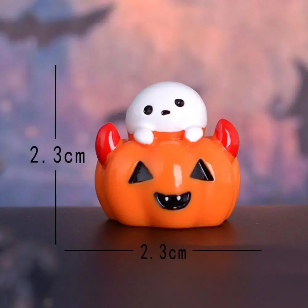 An orange pumpkin figurine with a white bear face and red ears, displayed against a blurred background.