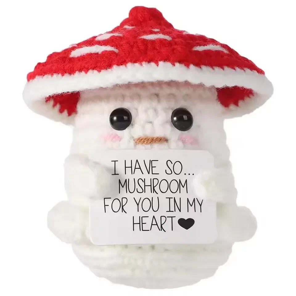 Handmade crochet owl with a red and white spotted mushroom hat and a white body.