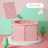 A pink foldable baby potty training seat is displayed on a white stand with a green background and a white cloud.
