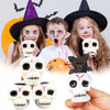 A group of people holding Halloween squeeze stress balls shaped like skulls and cats.